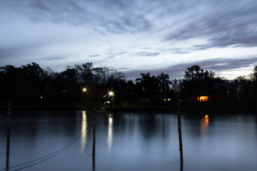 SILHOUETTE OF TREES IN A SUNSET OVER THE RIVER