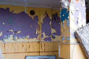 Walls with peeling paint in an abandoned room.
