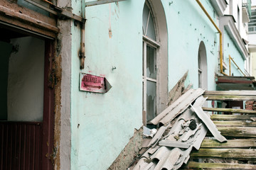 Wall of a Russian abandoned house. Translation of the inscription on the plate: 