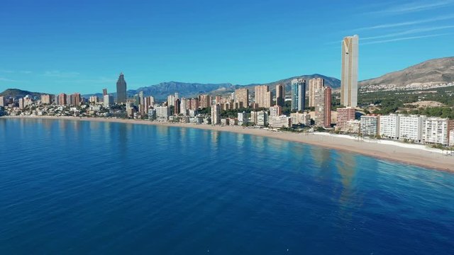 Benidorm - Mediterranean cityscape at sunrise. Spanish coast and high rise skyline of benidorm seaside resort. Aerial wide angle view at this summer holiday destination. 