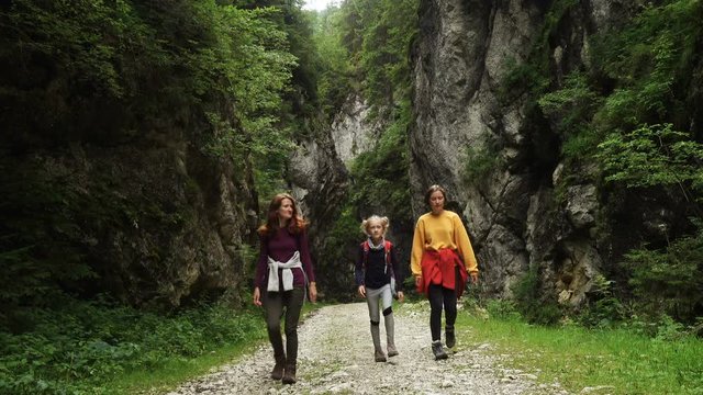 active family hiking by the Prapastiile Zarnestiului canyon, Piatra Craiului National Park, Romania