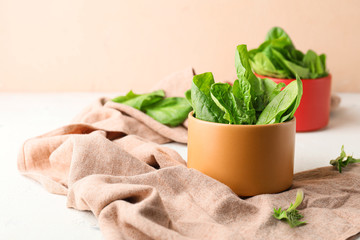 Bowl with fresh spinach on table