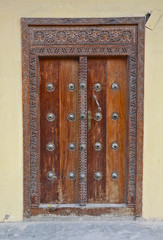 A wooden door, with traditional carvings, in Stonetown, Zanzibar. 