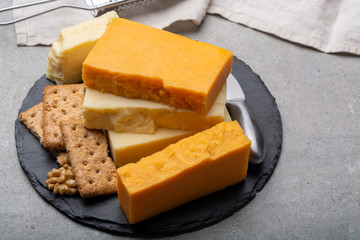 Cheese collection, matured and orange original British cheddar cheese in blocks served with crackers