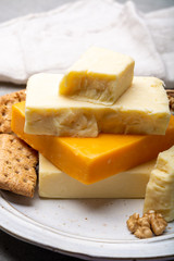 Cheese collection, matured and orange original British cheddar cheese in blocks served with crackers