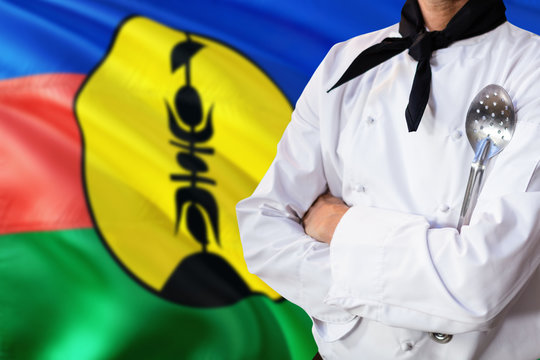New Caledonia Domestic Food Concept. Professional Chef In White Uniform Is Standing With Metal Spatula. Copy Space For Text.