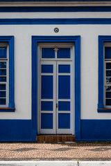 Obraz premium Windows and door with blue shutters