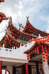 Fototapeta premium KUALA LUMPUR, MALAYSIA Pagoda roof top design at Tian Hou Temple, decorated with strings of red lanterns