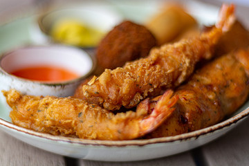 Dutch snacks for beer or wine, tempura shrimps, skewered chicken, bitterballs and hot dip sauces