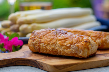 Pastry with bacon and white asparagus vegetables ready to eat served in spring garden