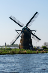 Traditional Dutch wind mill built along the canal in North Holland, spring landscape