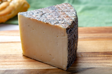Italian cheese, piece of mature Tuscan Pecorino sheep cheese served with olive bread and tomatoes