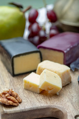 Mini black and dark red waxed cheddar cheeses made from West Country milk and and age-old methods in England