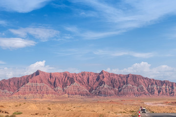 Fototapeta na wymiar The red rock formations of mountain range of Danxia landform in Xinjiang of China