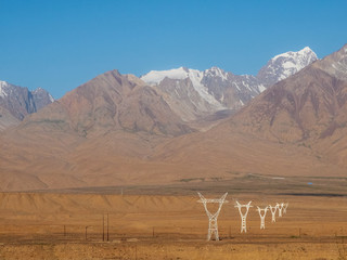 Pylons of high-voltage power lines in the barren mountains