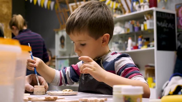 Leisure activity for preschooler. Art workshop background. Developing creativity, montessori concept. Child paint wity paintbrush. Kindergarten concept