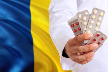 Chad pharmacy and medicine concept. Doctor holding pills tablet on national flag background. Health...
