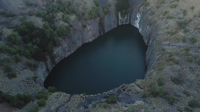 4K high quality sunny sunrise morning aerial panorama footage of spectacular scenic The Big Hole water filled old diamond mine site in Kimberley, capital of Northern Cape Province, South Africa