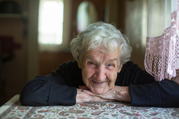 Close-up portrait of an old pretty gray-haired woman.