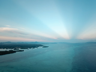 Aerial wide panorama of Bum Bum Island against an early morning blue sky colourful sunrise in...