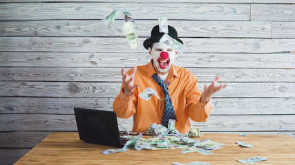 clown businessman with money in his hand. Concept on big boss with money.