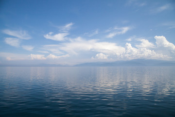 Beautiful seascape Baikal Lake silhouette of the cloud and calm water on the sunny morning