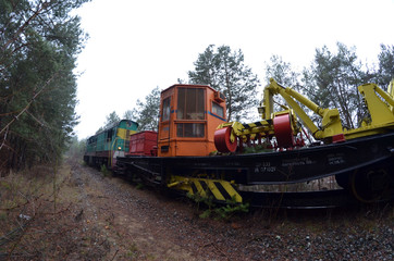 Special railway service train cuts overhanging branches. Near Kiev, Ukraine