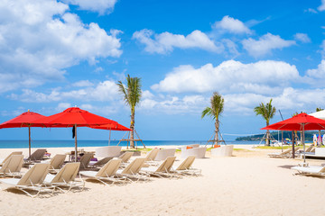 red beach umbrella and beach chair on the beach