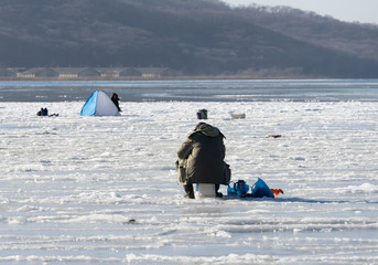 Landscape with people on winter fishing