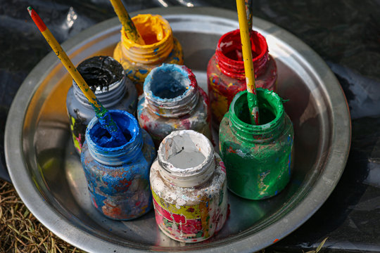 Used poster color bottles with brush for painting shot in selective focus