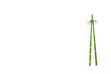 Chopsticks - green wooden utensil for sushi and rolls - on white background top-down copy space