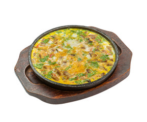  These mushrooms in a creamy sauce are in a clay dish on a wooden board on a white background.