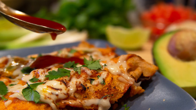 Traditional mexican enchiladas with chicken meat, spicy tomato sauce and cheese