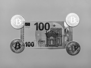 Paper money bill and bitcoins in the corners in black and white presenting different choices of...