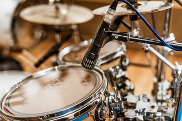 A view of a drum kit set up ready for recording in a commercial recording studio with microphones...