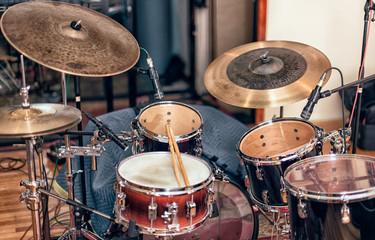 A view of a drum kit set up for recording in a recording studio with microphones in place