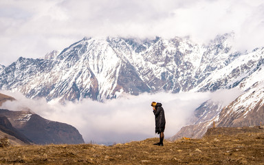 Woman and phone with view from the road near Stepantsminda , Kazbegi mountain , Georgia