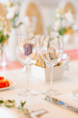 Two empty glass glasses in the wedding decor on a festive Banquet table