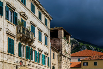 Fototapeta na wymiar Picturesque brick walls of houses and City Tower in the Old town of Kotor Montenegro in the Balkans on the Adriatic Sea