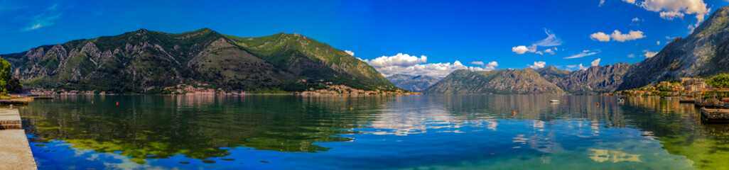 Fototapeta na wymiar Panorama of Kotor Bay or Boka Kotorska, mountains reflecting in clear water, Balkans, Montenegro on the Adriatic Sea