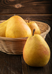 Ripe yellow pears on a wooden table
