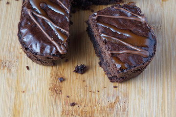 Close up of moist dark chocolate brownies over wooden table.