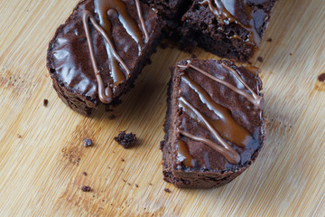 Close up of moist dark chocolate brownies over wooden table.