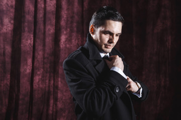 Handsome man in a business suit on a dark background
