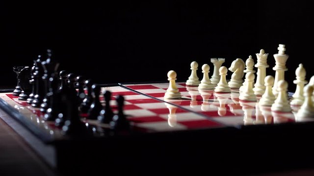 White first move e4 with eye level smooth rotating shot of chessboard in dramatic lighting with full pieces on white and black sides - 4K