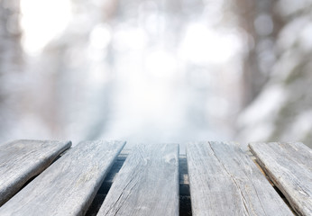 empty wooden tabletop on the winter forest background	