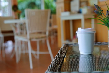 take away cup for hot coffee drink put on glass table in cafe shop