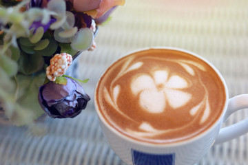 frangipani plumeria fragrant flower of latte art in hot coffee drink put on table in cafe restaurant
