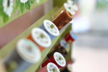 shelf of colorful thread set material for sewing embroidery