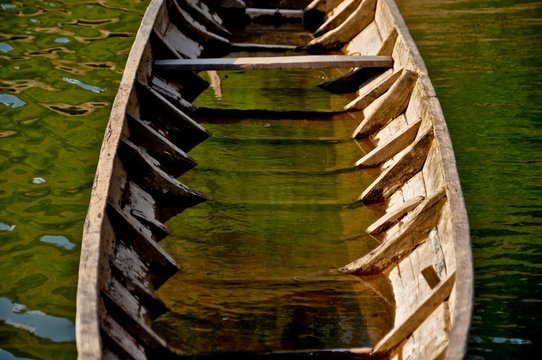 Old fishing boat partially filled with water on the Mekong River